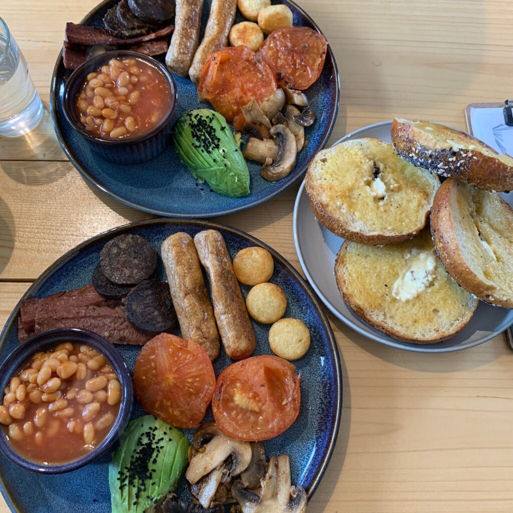 Vegan English breakfast with a plate of bagels next to it