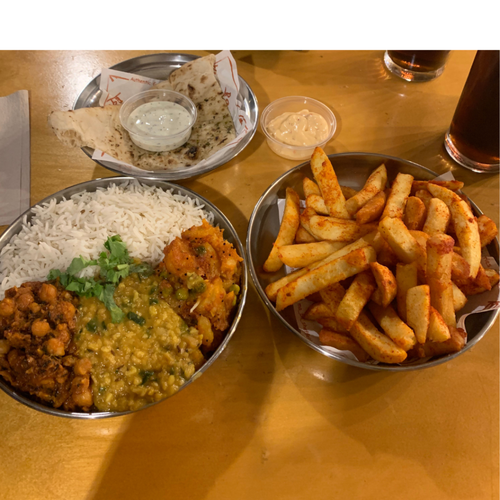 3 Indian food dishes containing rice, curry, chips and naan bread 