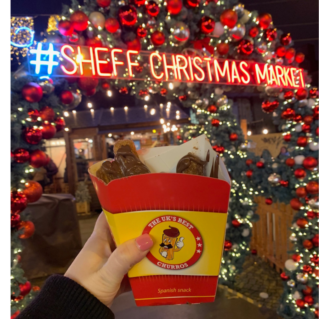 Churros box infront of Sheffield Christmas Markets sign